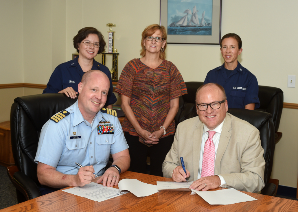 Capt. Patrick Nelson, Sector Commander of U.S. Coast Guard Sector Sault Ste. Marie, and Lake Superior State University President Rodney Hanley renew an agreement on Aug. 8 that encourages active-duty personnel to pursue a degree at LSSU